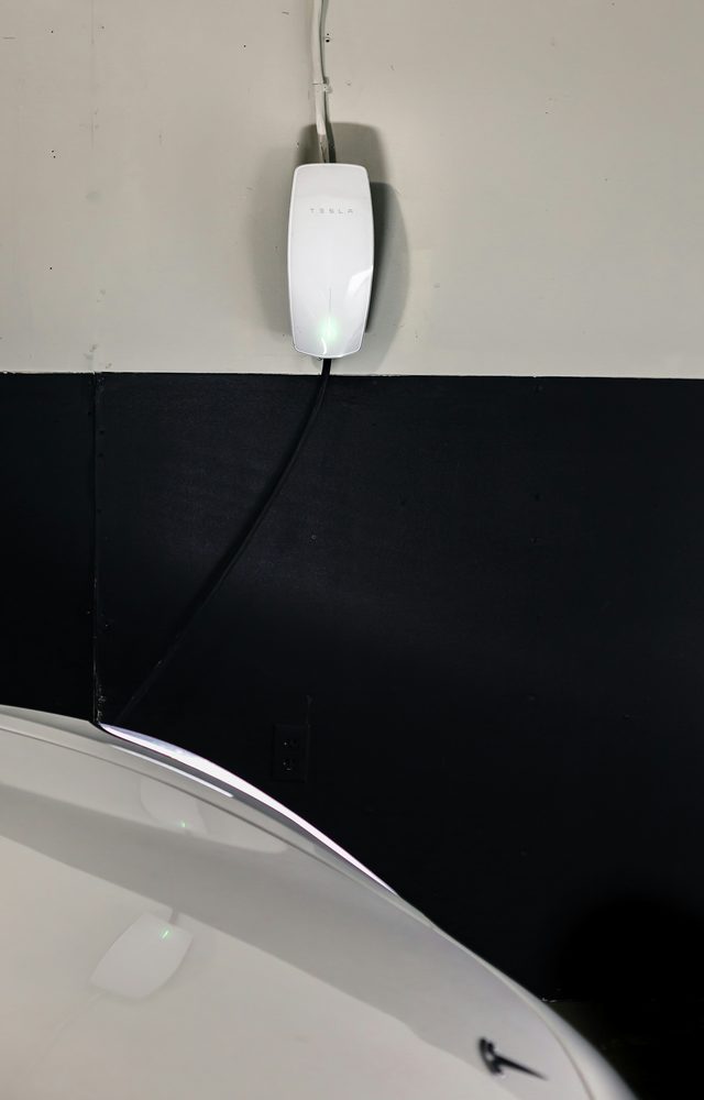 Residential charging station installed on an exterior wall