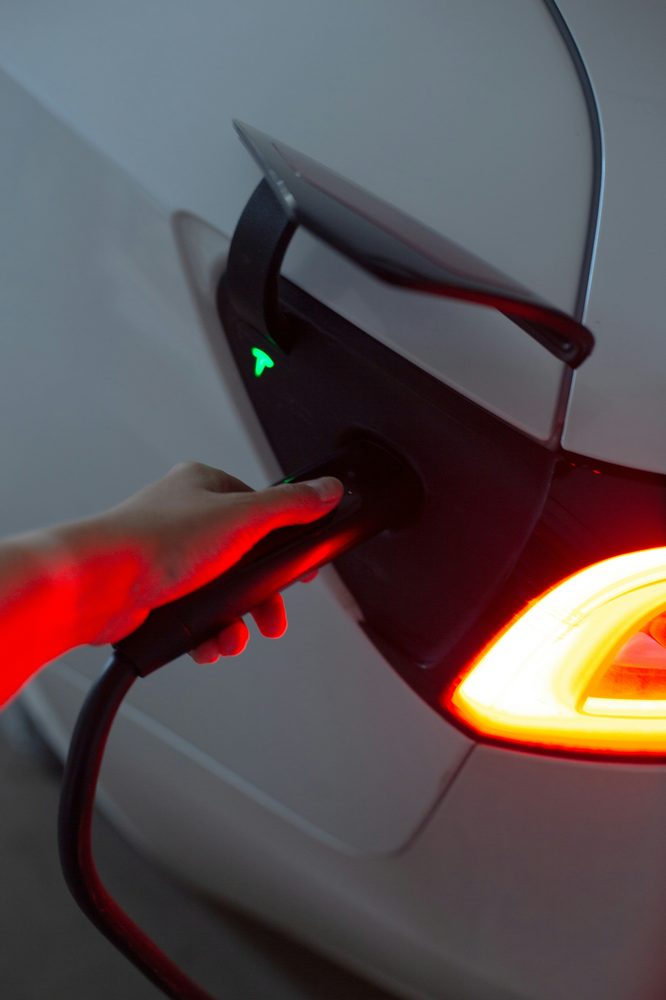 Close-up of a Tesla charge port with the connector engaged