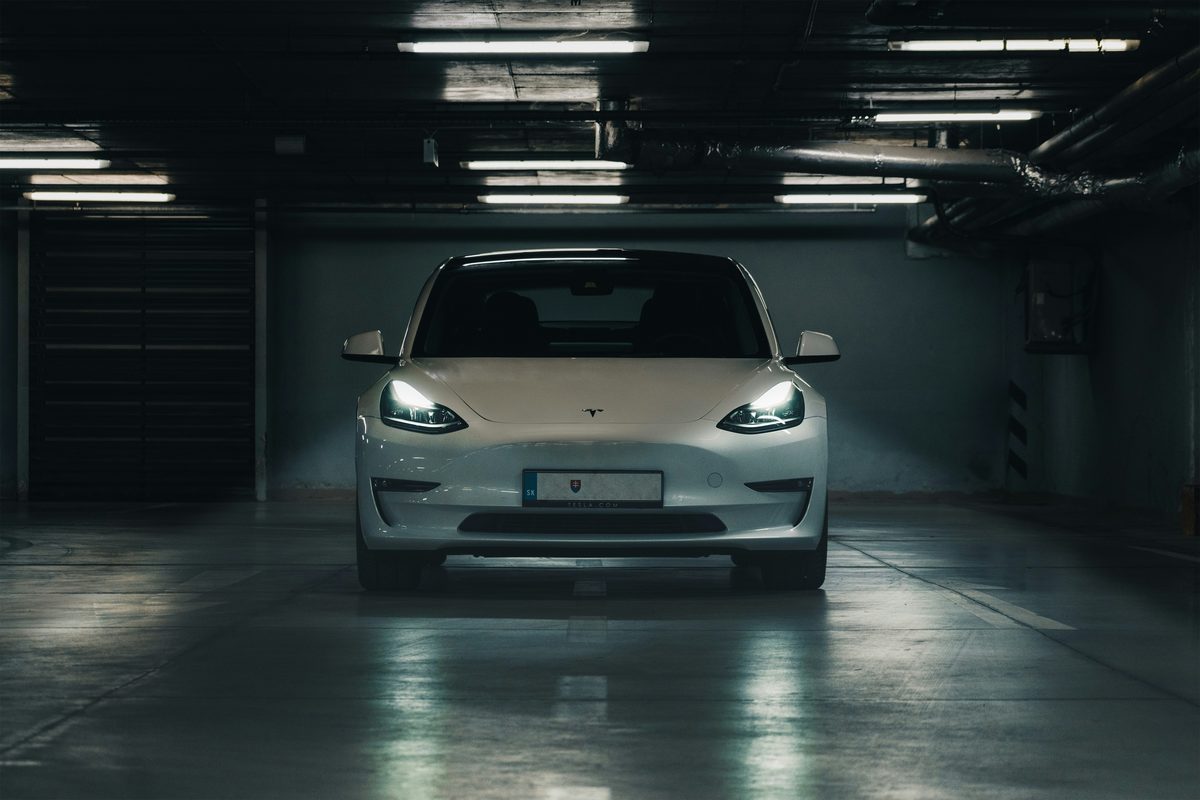 Tesla sedan viewed from the front on a paved surface